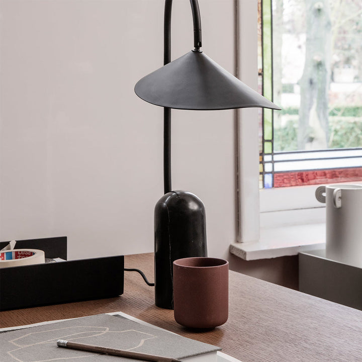 Minimalist black lamp for living rooms, arched and anchored by a beautiful marble base.