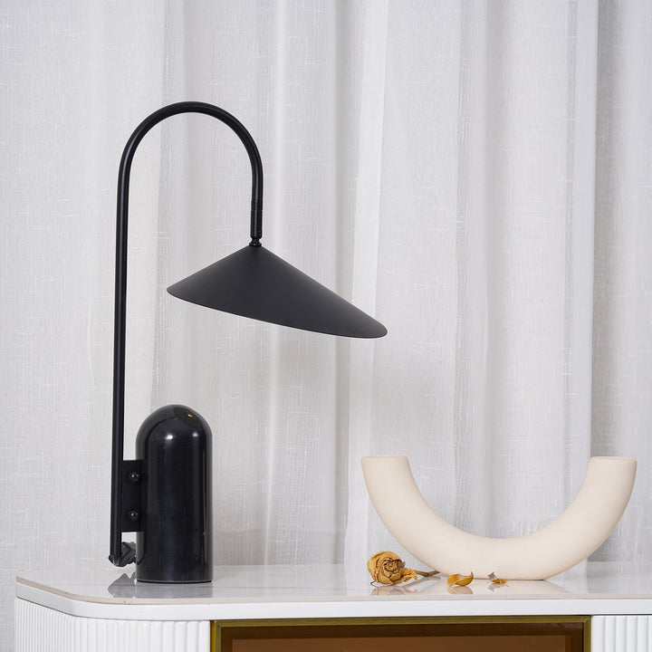 Sculptural desk lamp, black, modern arched design with a chic marble base.