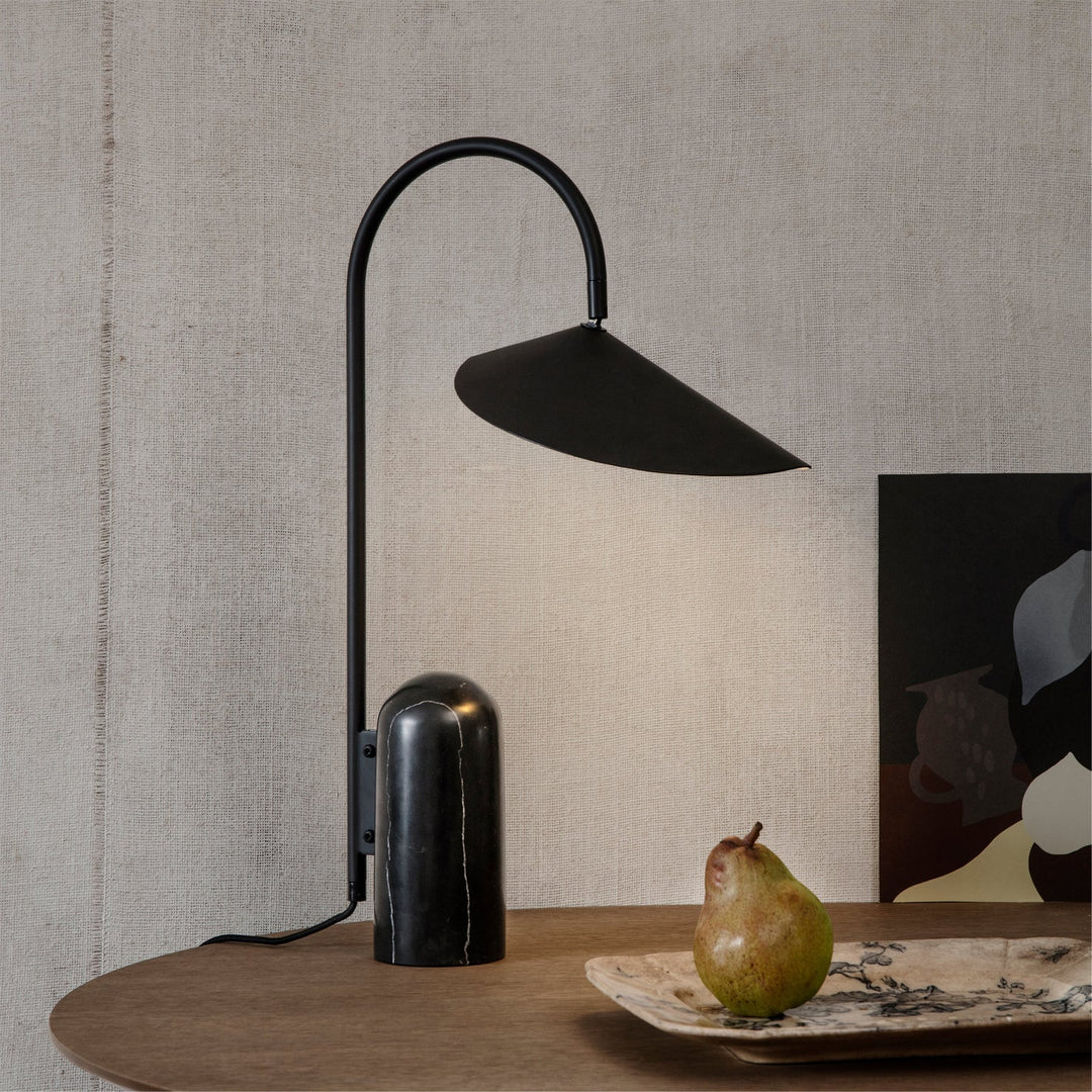 Bedside table lamp, beige, contemporary, with a graceful arch and sturdy marble base.