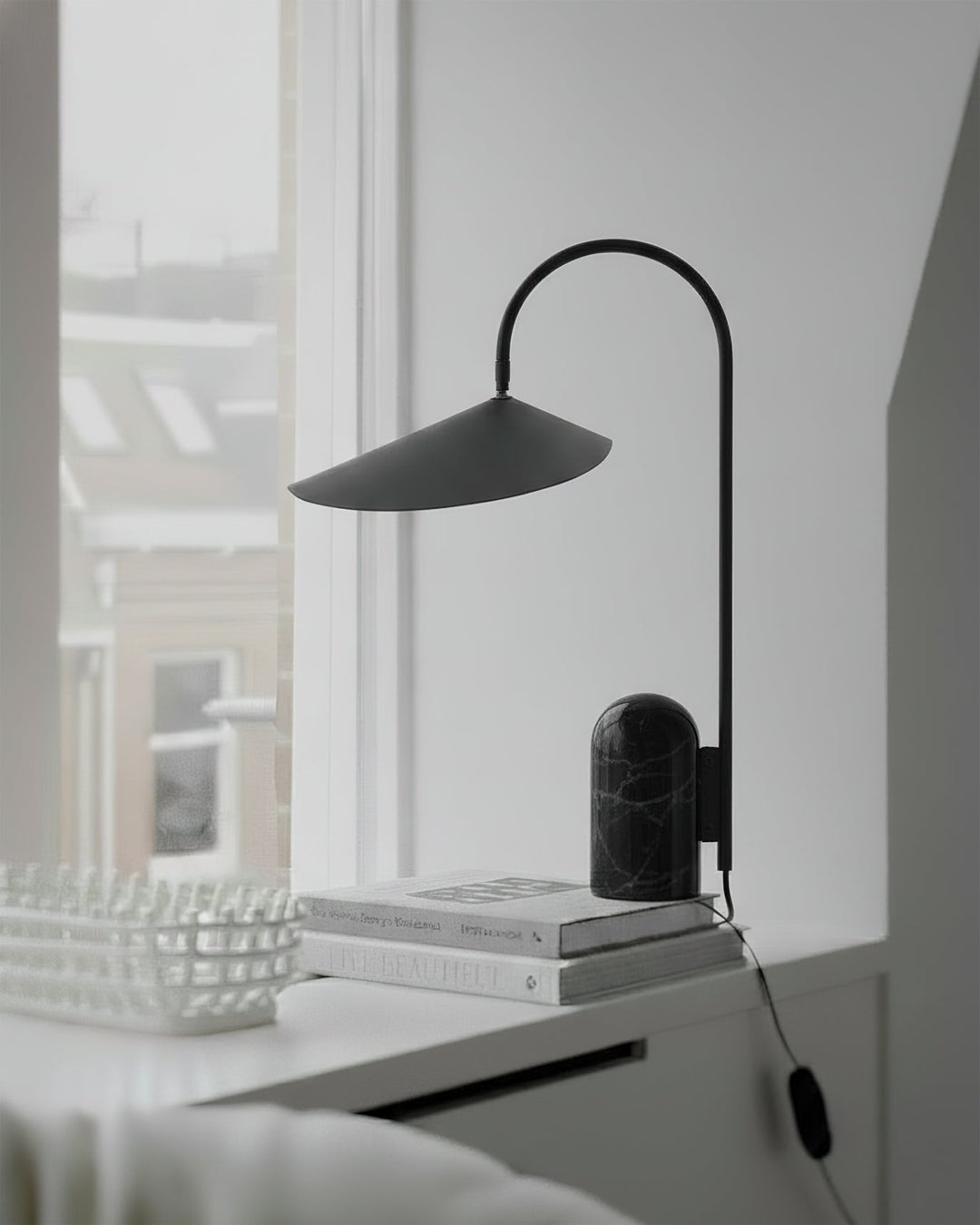 Arched desk lamp, black, sleek modern design with a heavy marble base for workspaces.