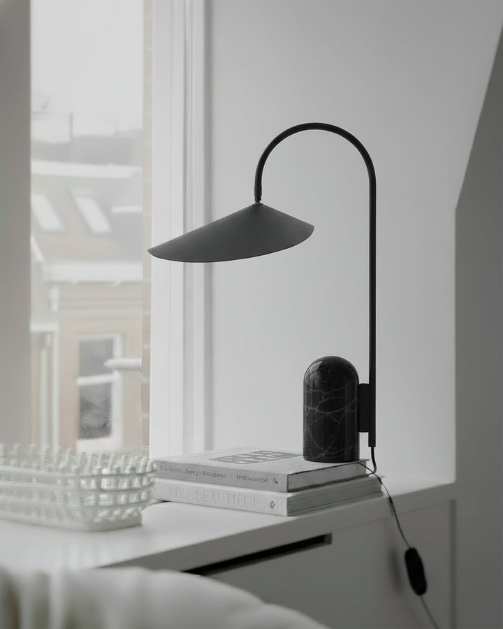 Arched desk lamp, black, sleek modern design with a heavy marble base for workspaces.