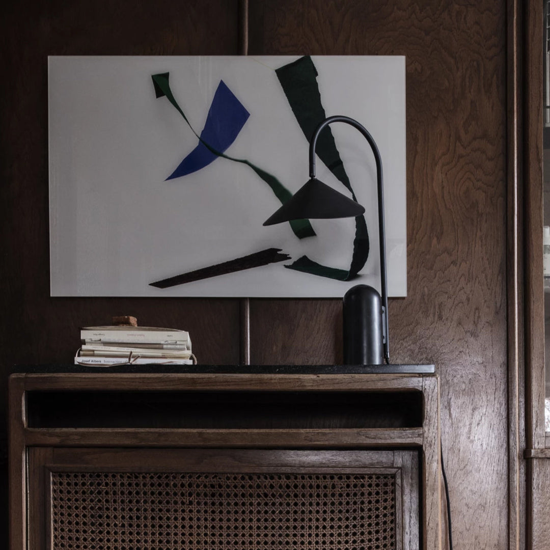 Minimalist bedside lamp, beige, arched, and grounded by a beautiful marble base.