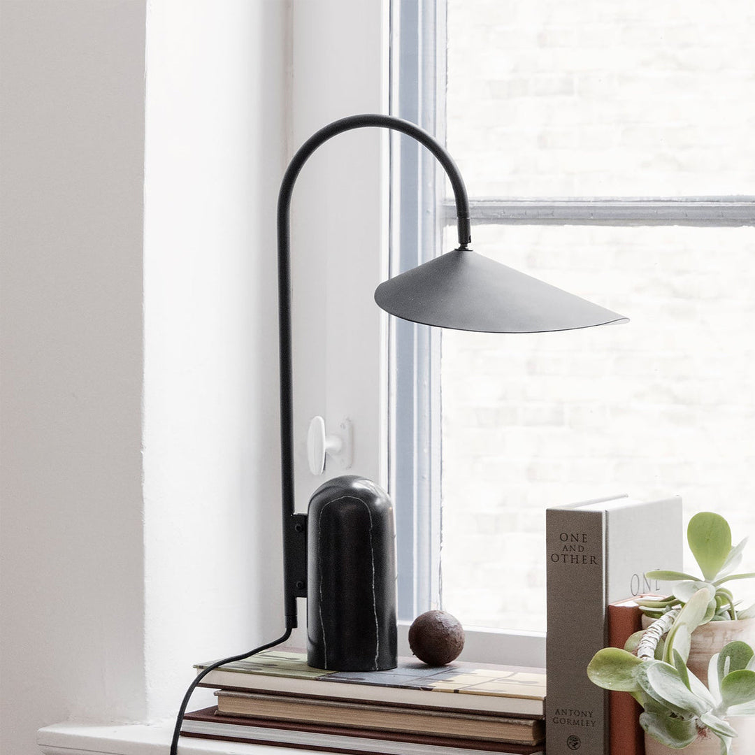 Minimalist living room lamp, black, with an arched frame & luxurious marble base accent.
