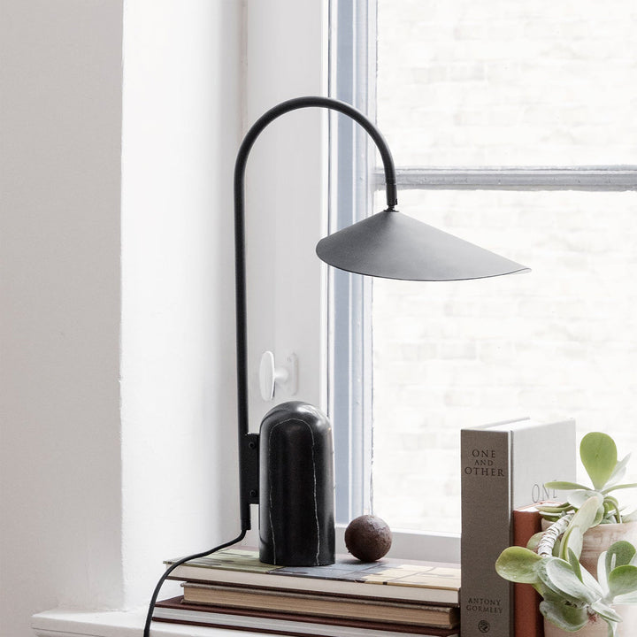 Minimalist living room lamp, black, with an arched frame & luxurious marble base accent.