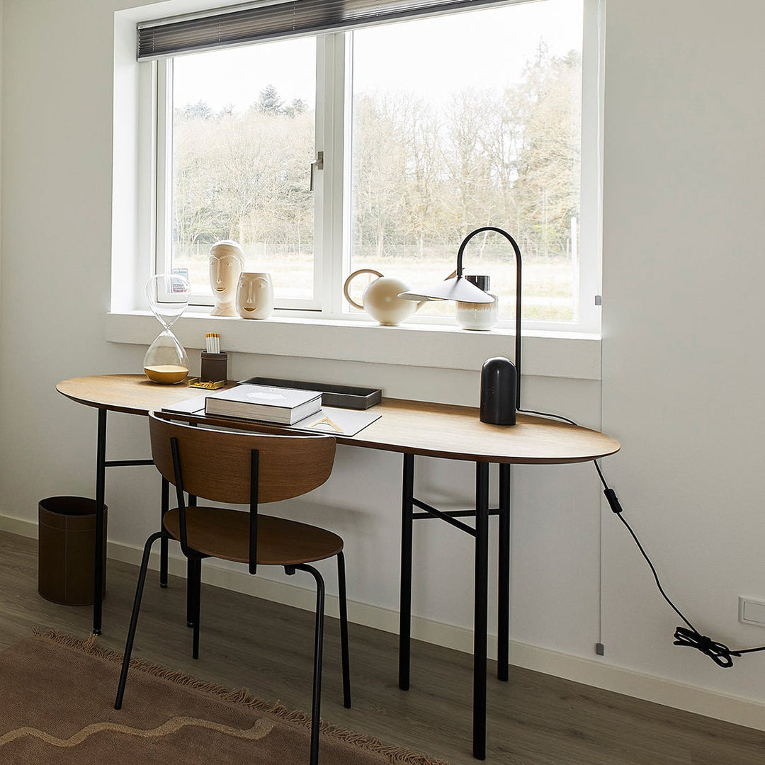 Sculptural beige lamp, minimalist, with an arched stand & elegant marble base for decor.