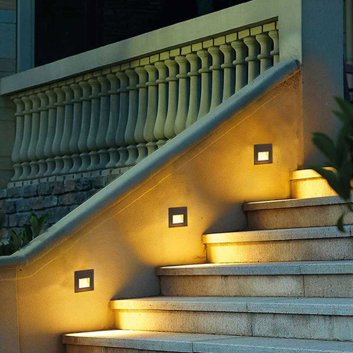 Outdoor LED step light in modern square design, for patio & garden pathways.