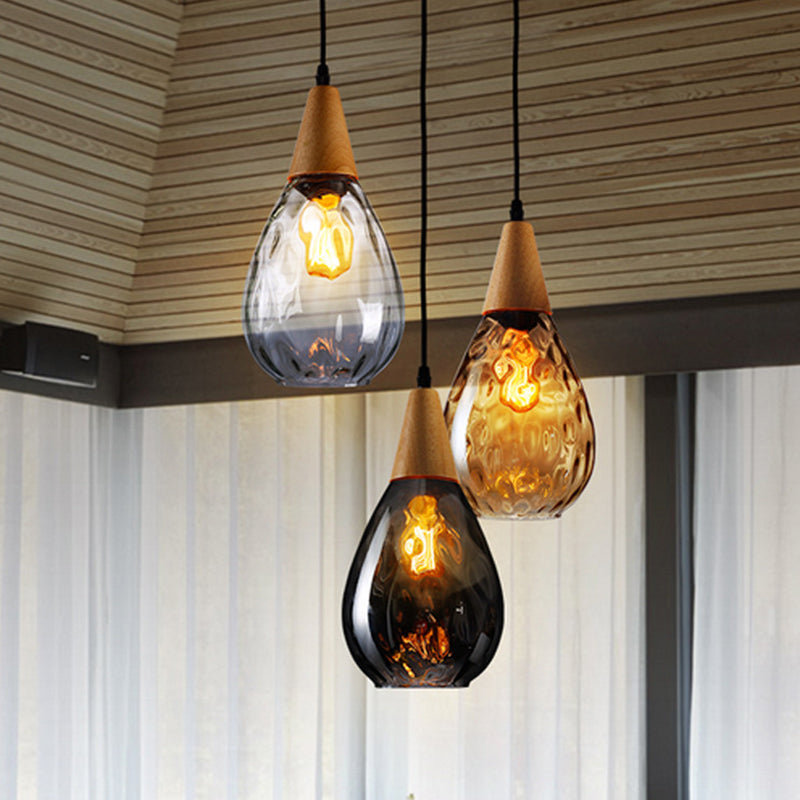 Modern teardrop glass pendant light, elegant hanging ceiling lamp for home decor.