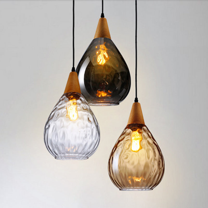 Chic teardrop glass pendant lamp, modern ceiling light adding elegance to home decor.