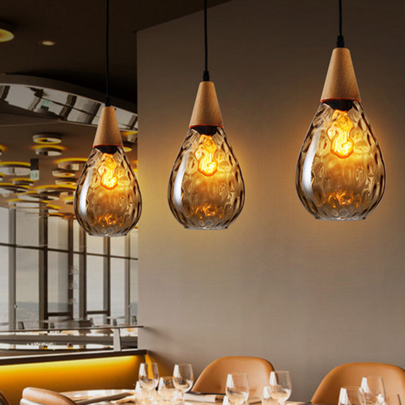 Ambient teardrop glass pendant light, stylish ceiling lamp for cozy living room lighting.