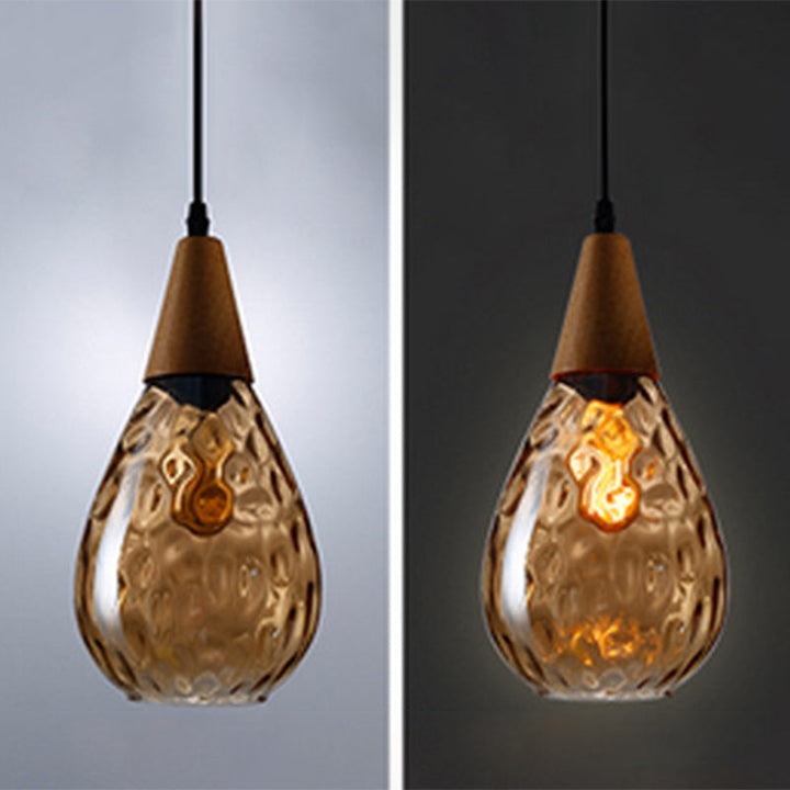 Stylish teardrop glass pendant light fixture, perfect modern ceiling lamp for kitchens.