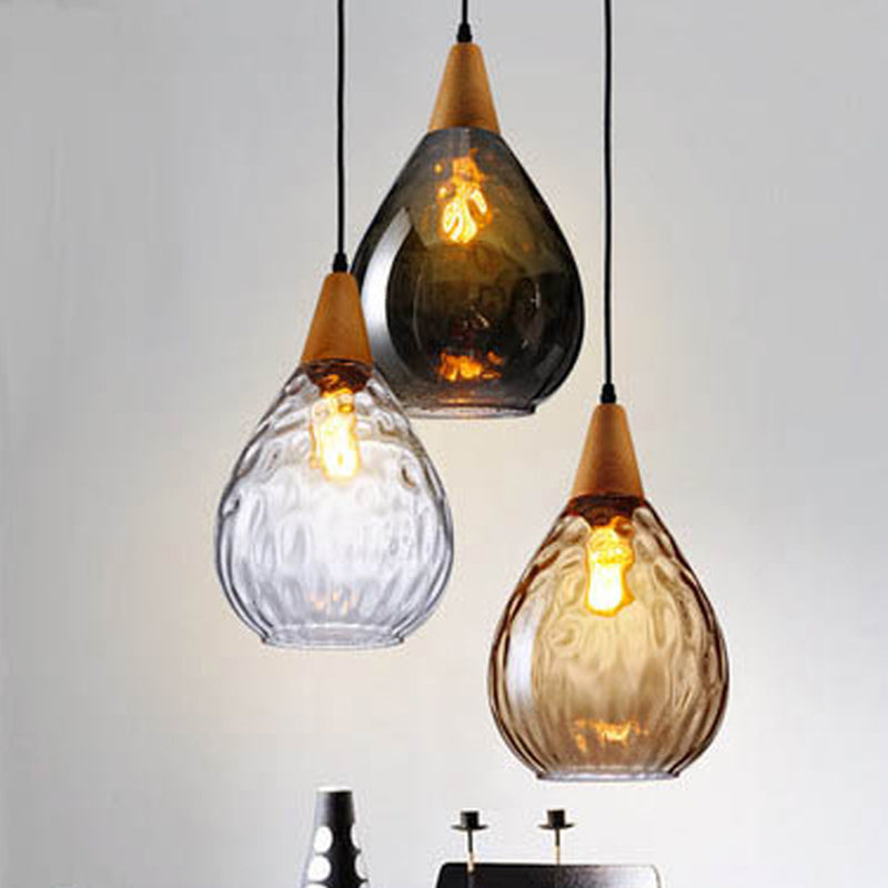 Elegant teardrop pendant lamp, modern glass hanging light for living room ambient decor.