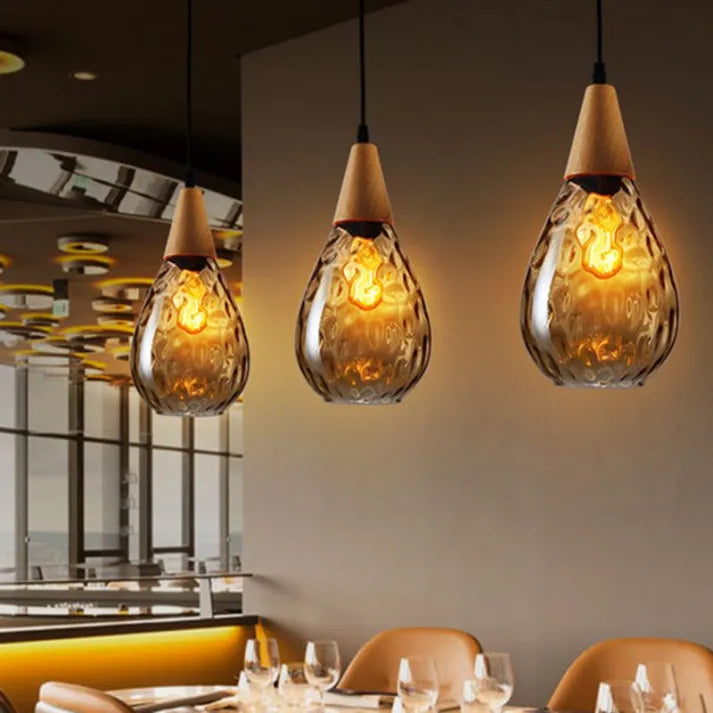 Modern wood & glass teardrop pendant, elegant ceiling lamp for sophisticated homes.