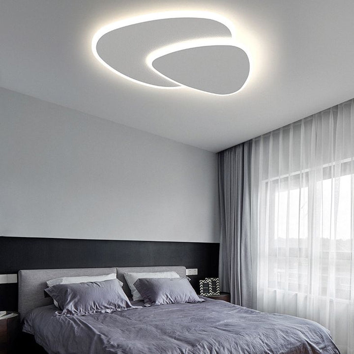 Unique triangular LED flush mount ceiling light, casting modern ambient illumination.
