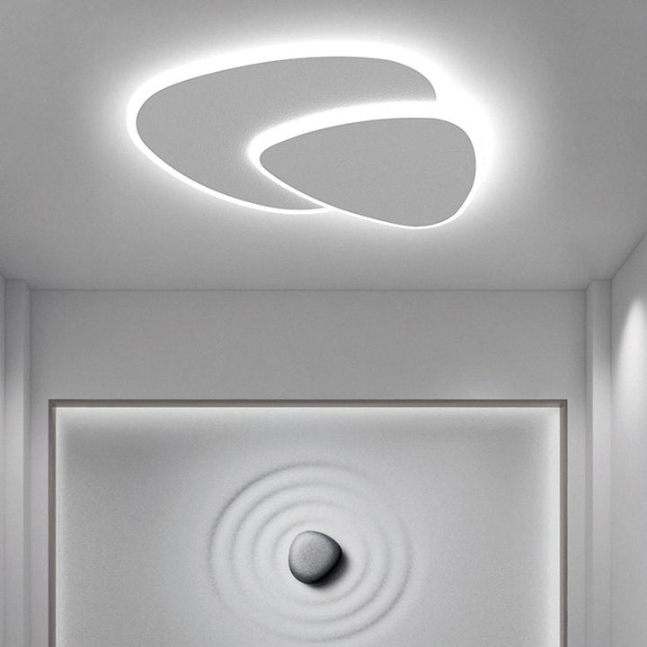 Minimalist triangle LED flush mount light, sleek ceiling fixture for modern homes.