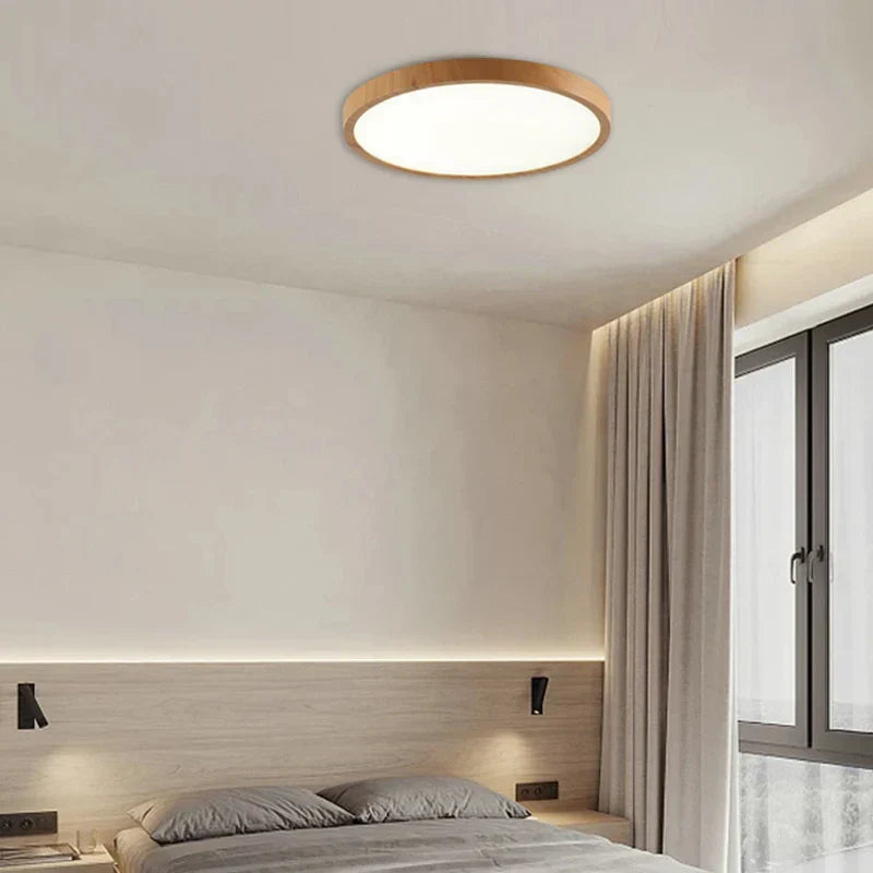 Minimalist ultrathin circular LED ceiling light, energy-efficient with a sleek walnut wood design.