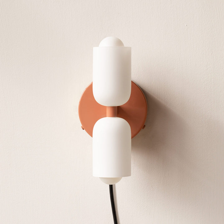 Chic modern wall lamp, providing subtle uplight downlight for sophisticated interior design.