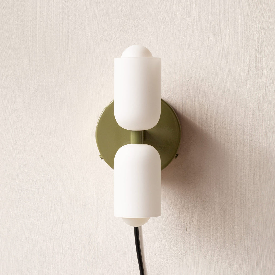Contemporary wall sconce featuring uplight/downlight for subtle ambient illumination.
