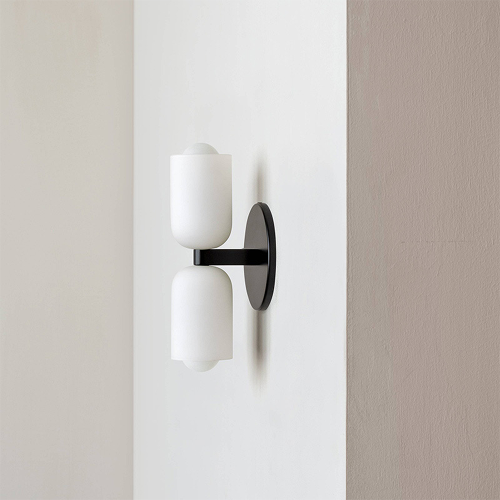 Modern minimalist wall lamp with integrated uplight & downlight for a subtle glow.
