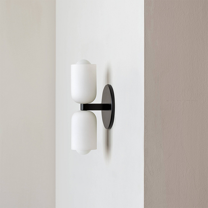 Modern minimalist wall lamp with integrated uplight & downlight for a subtle glow.