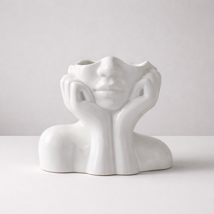 Modern white ceramic face vase, artistic tabletop decor. Unique decorative home accent for living room styling.