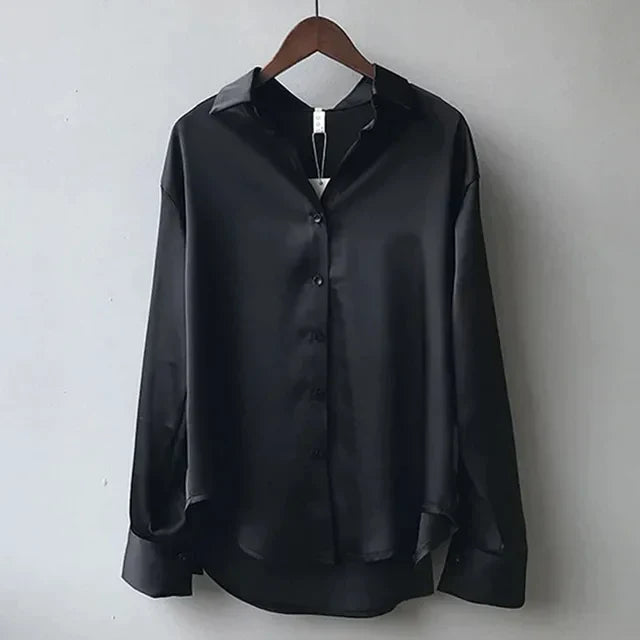 Versatile women's modern button down blouse. Long sleeve top for elegant workwear, office style, or casual chic.