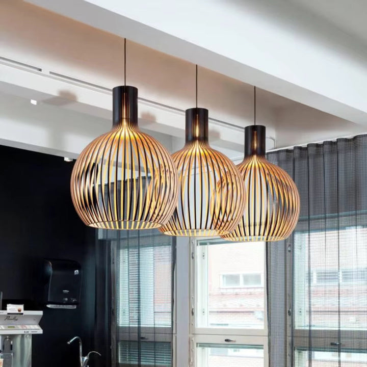 Natura Orb Pendant Lamp with organic wood design providing cozy ambient light.