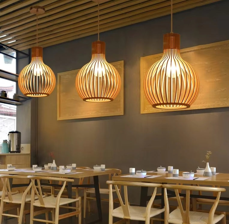 Natura Orb pendant lamp illuminating a modern rustic living room interior.