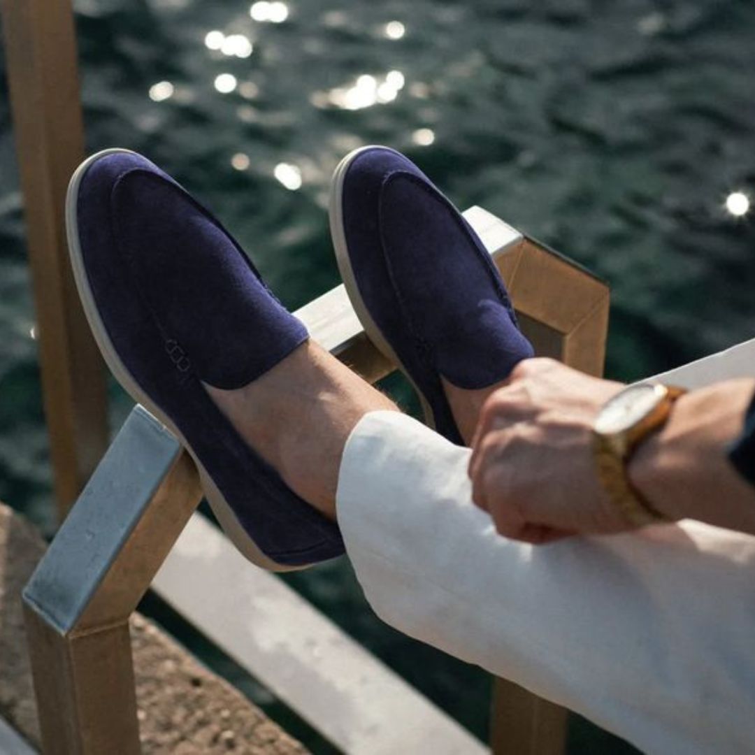 Navy blue men's slip-on loafers, round toe, stitched detail for casual all-day comfort.