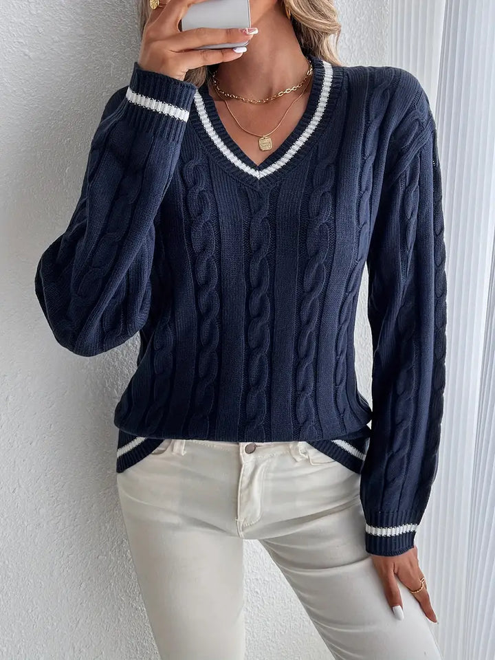 Navy blue women's V-neck cable knit sweater with stylish striped trim. Perfect for fall and winter.