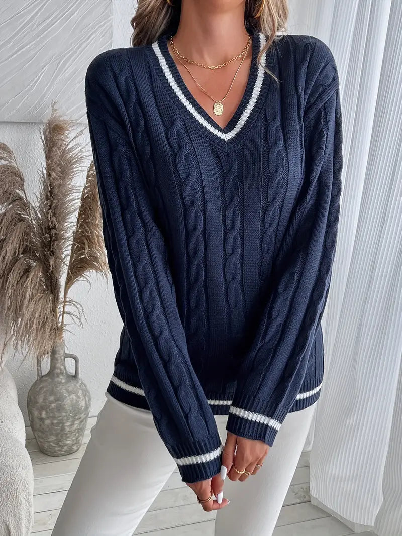 Chic women's V-neck cable knit sweater in navy with striped trim, ideal for cozy fall and winter outfits.