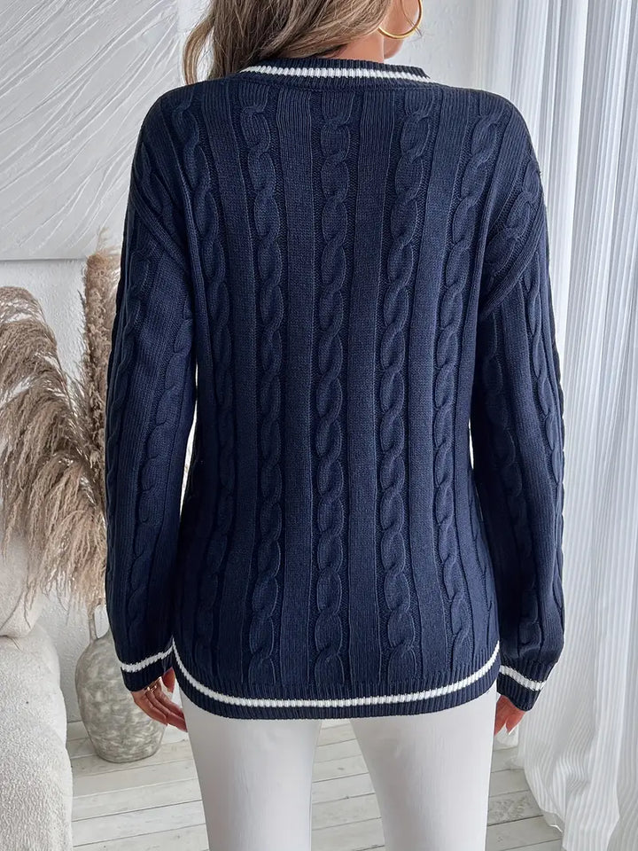 Cozy navy V-neck cable knit sweater for women with stylish striped trim, essential for winter warmth.