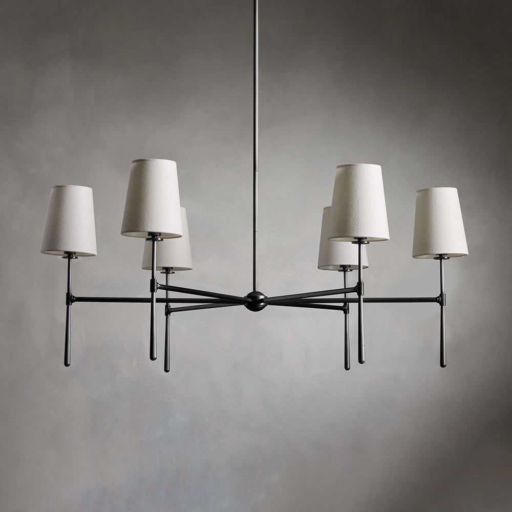 Living room Nevell chandelier; brass mid-century design, sophisticated ambient light.