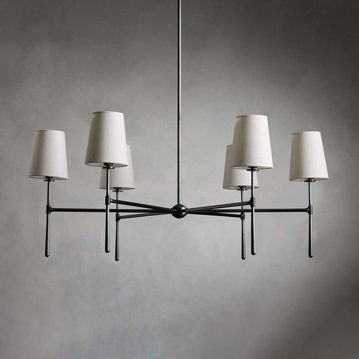 Living room Nevell chandelier; brass mid-century design, sophisticated ambient light.