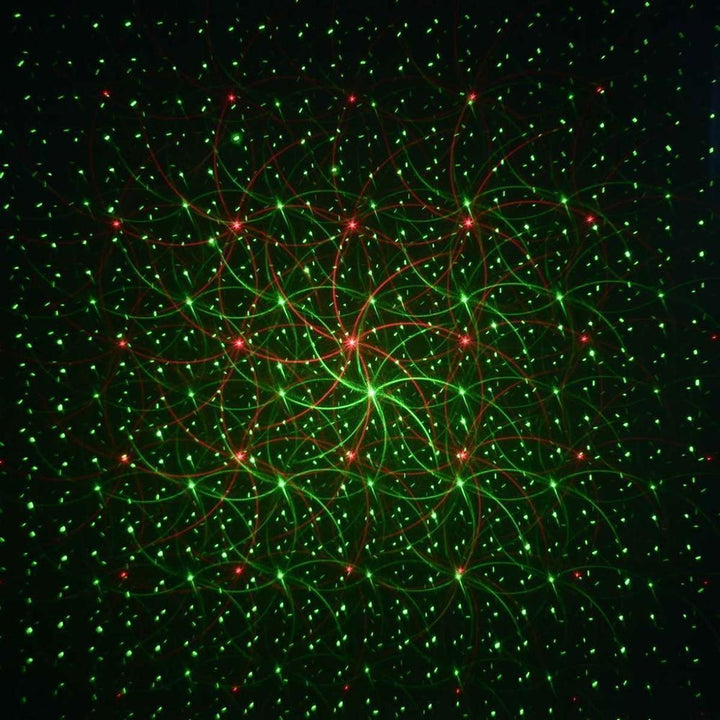 Remote control outdoor Christmas laser light projector, projecting red & green holiday lights on homes.