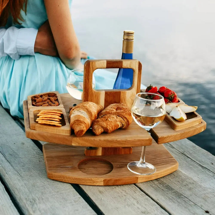 Portable wooden picnic table for outdoor dining, with wine glass slots & snack compartments. Perfect for parks.