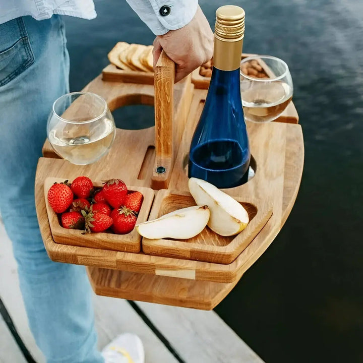 Compact foldable wood table, ideal for camping & beach trips. Features drink holders & snack tray.