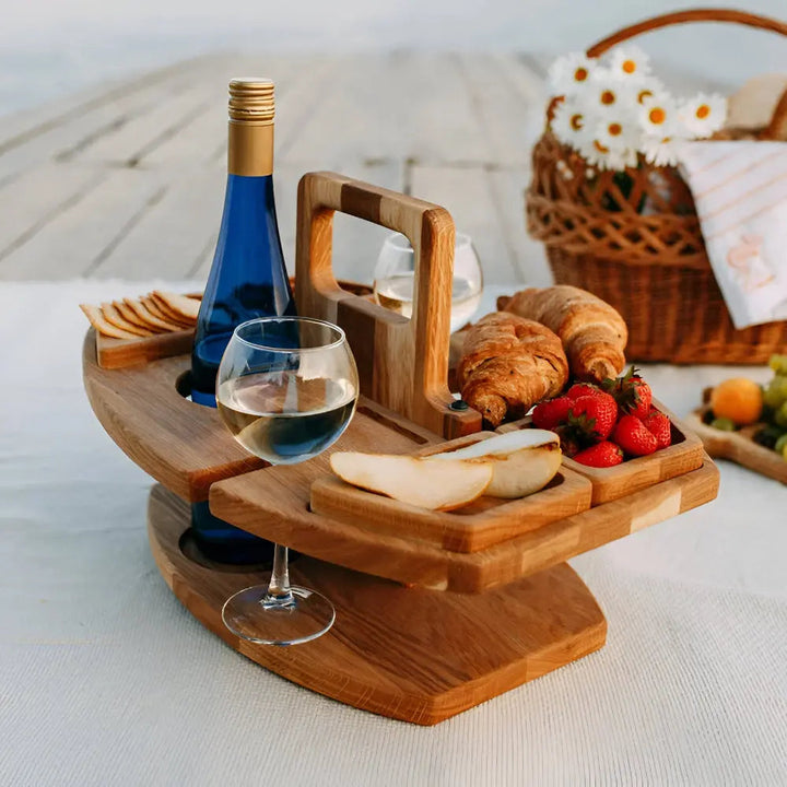 Space-saving foldable wooden picnic table for easy transport & storage. Includes built-in drink & snack holders.