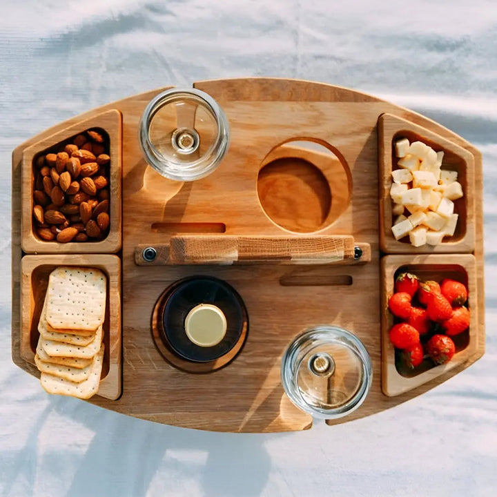 Wooden picnic table with convenient built-in wine glass holders & snack sections. Great for outdoor entertaining.