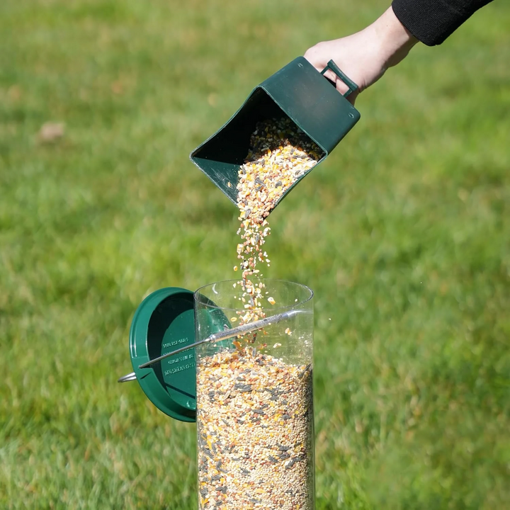 Close-up of a squirrel-proof bird feeder's spinning perch, deterring squirrels from accessing birdseed.