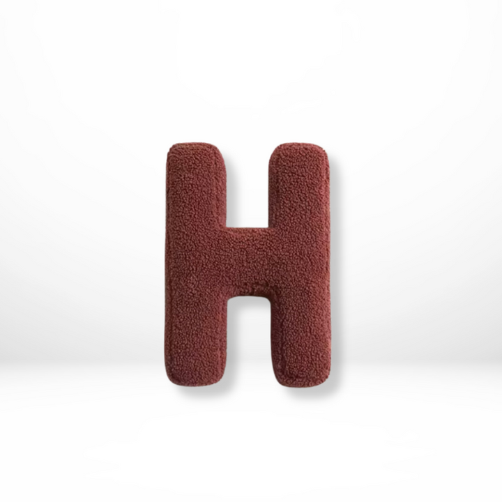 Plush velvet letter pillow, a custom initial accent for cozy bedroom decor.