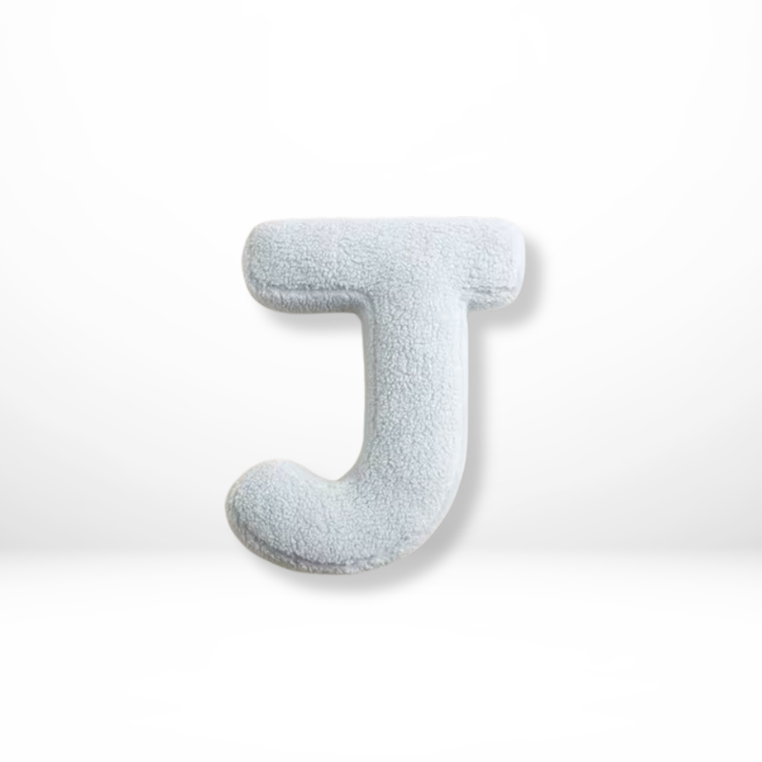 Luxurious velvet alphabet pillow, perfect for a personalized living room or bedroom accent.