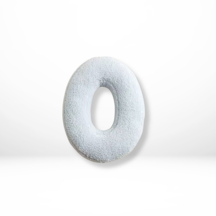 Personalized soft velvet cushion with initial, a cozy decorative piece for home.