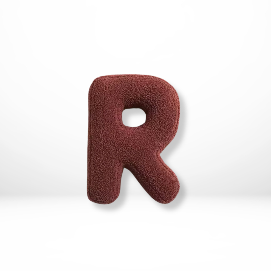 Personalized decorative velvet cushion, a soft initial accent for sophisticated home decor.