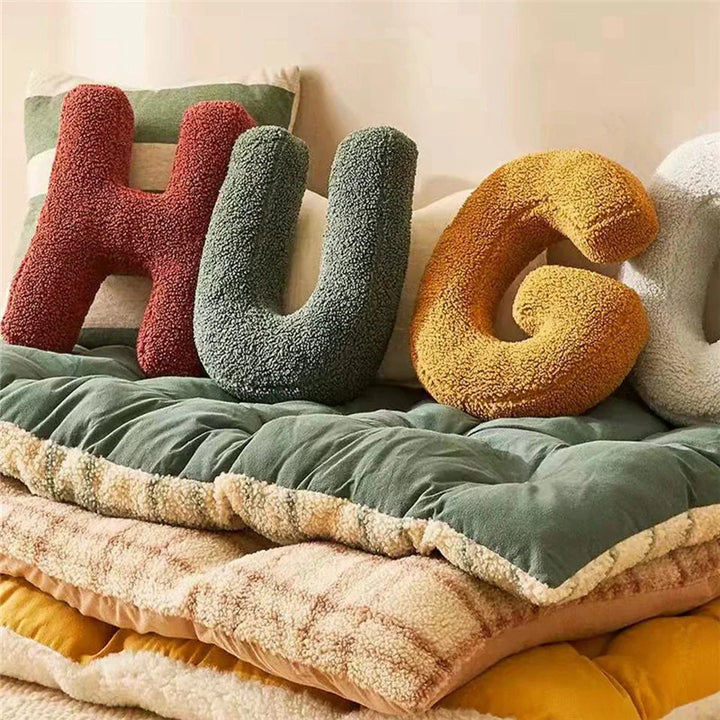 Custom initial velvet pillow, elegant decorative accent for modern home interior.