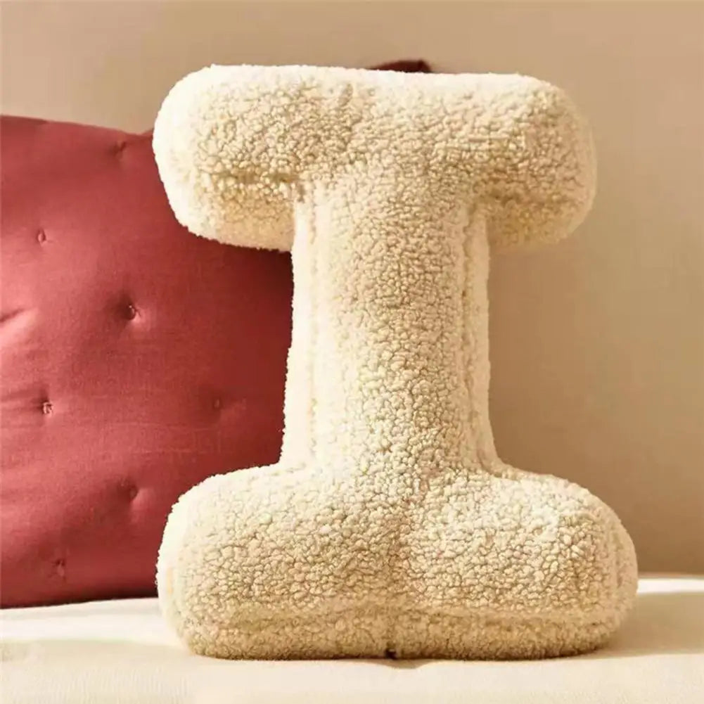 Soft personalized velvet initial cushion, cozy and stylish living room or bedroom decor.