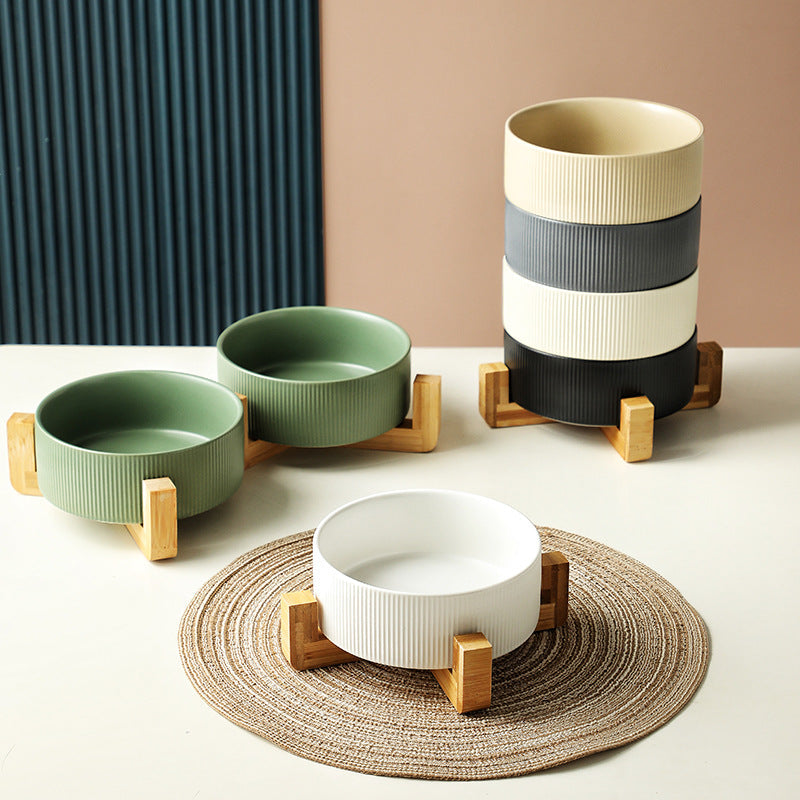 Stylish pet feeding station: two ceramic bowls in an elegant elevated wooden stand.