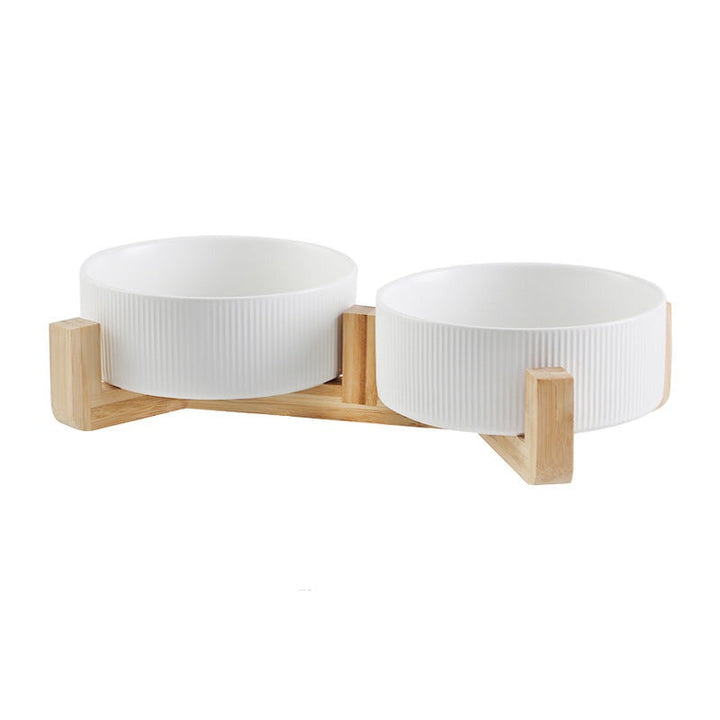 Ceramic pet bowls for food & water, neatly set in a sleek wooden elevated feeder.