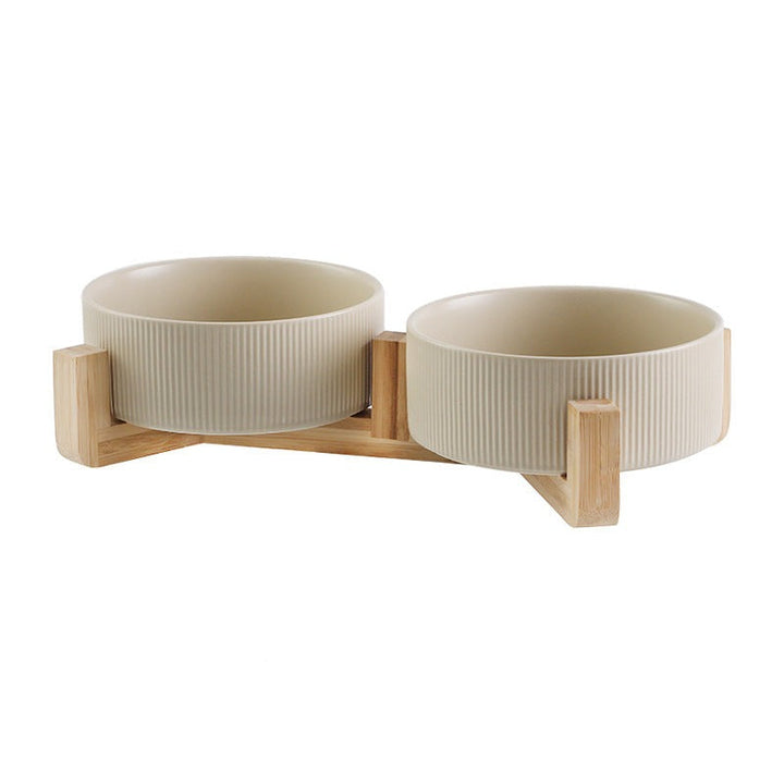 Beautiful pet bowl set: white ceramic bowls on a natural wood elevated feeding station.