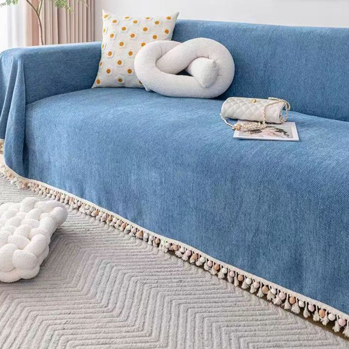 Stylish herringbone sofa cover with tassel fringe, a pet friendly couch throw for a modern boho home accent.