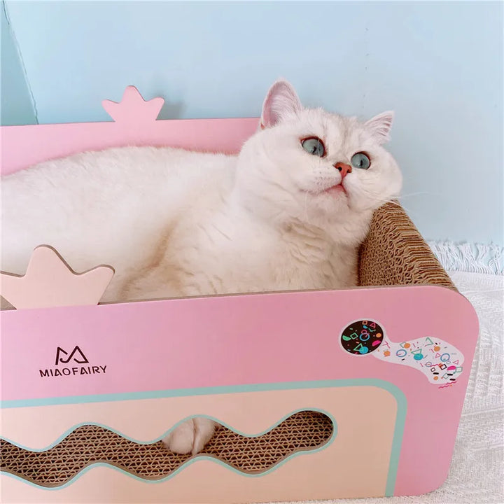 Pink cat scratching box with toys protects furniture. Ideal for kitten play & activity.